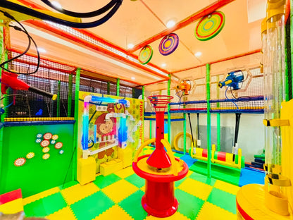 A colorful indoor playground with slides, swings, and a ball pit for children.