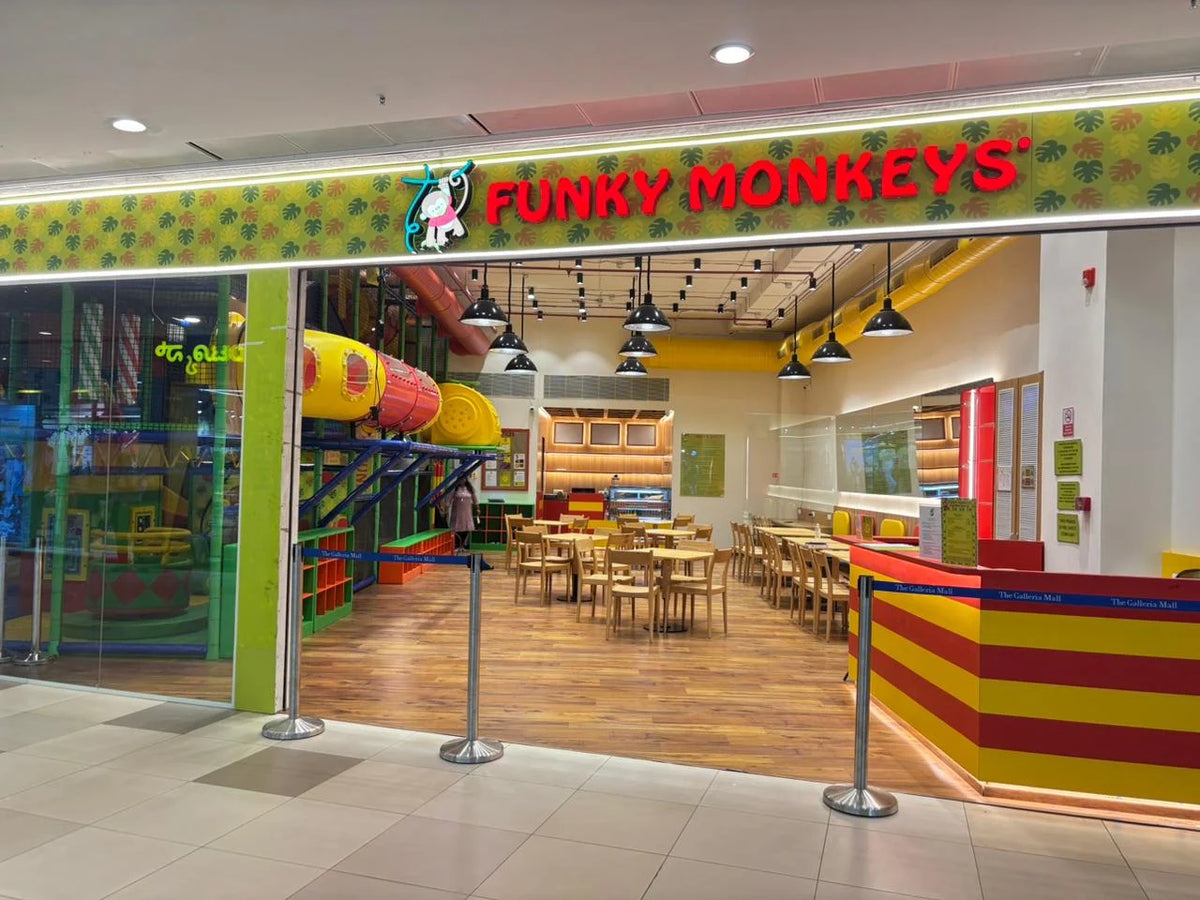 A brightly colored indoor playground and seating area for children and families.