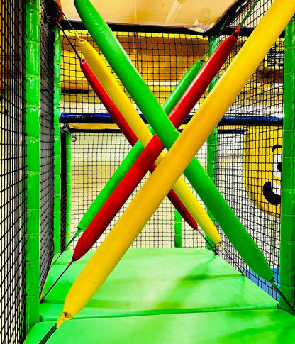 Colorful padded beams crisscross in a children's indoor play area.