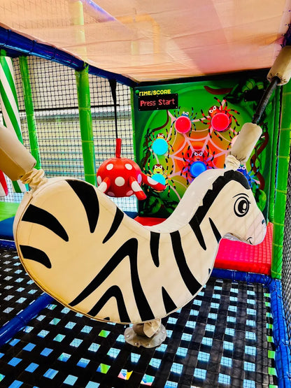 A zebra-themed ride in a colorful indoor playground.
