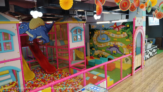 Bright indoor play area with colorful ball pit, dinosaur slide, and interactive wall games at Sapphire 90 Mall Gurgaon