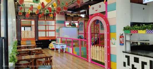 Bright indoor play area with pink archway and wooden fence next to trampoline and seating at Sapphire 90 Mall Gurgaon