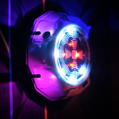 A close-up of a disco ball with colorful lights, casting purple and blue hues.