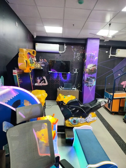 An arcade with VR games, racing simulators, and chairs.