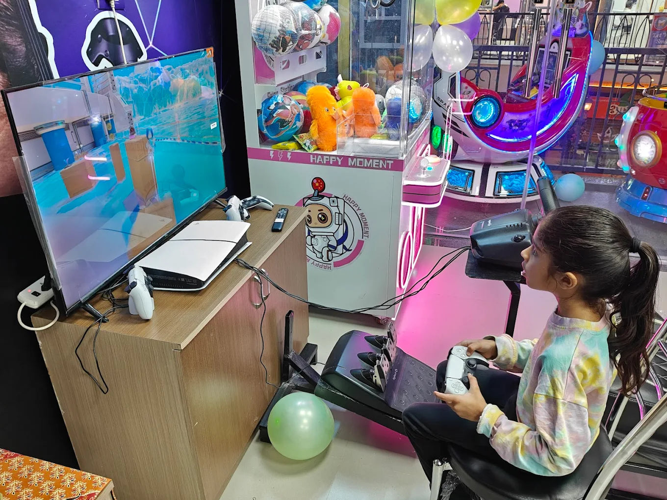 A young girl plays a video game at an arcade, holding a controller while sitting in a gaming chair.
