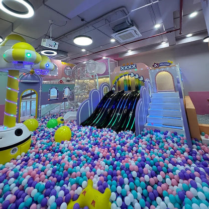 A colorful indoor playground filled with balls, slides, and climbing structures for children.