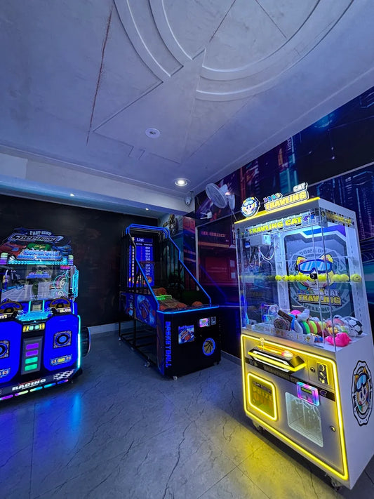 Arcade with racing, basketball, and claw machines.