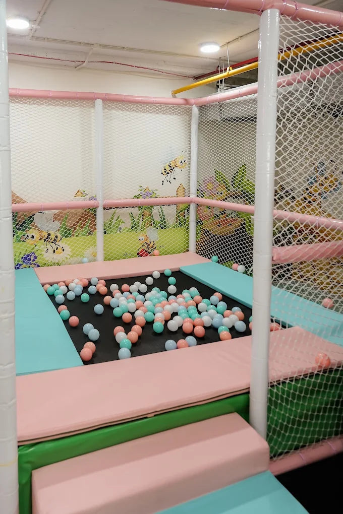 A ball pit filled with colorful balls in a children's play area.