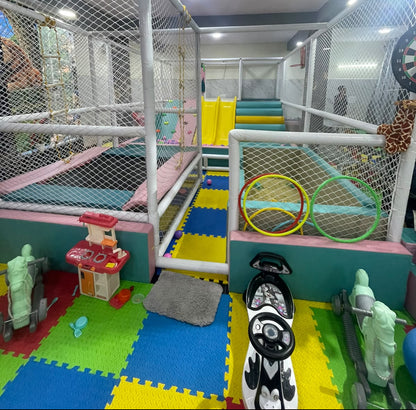 A colorful indoor playground with slides, trampolines, and toys for children.
