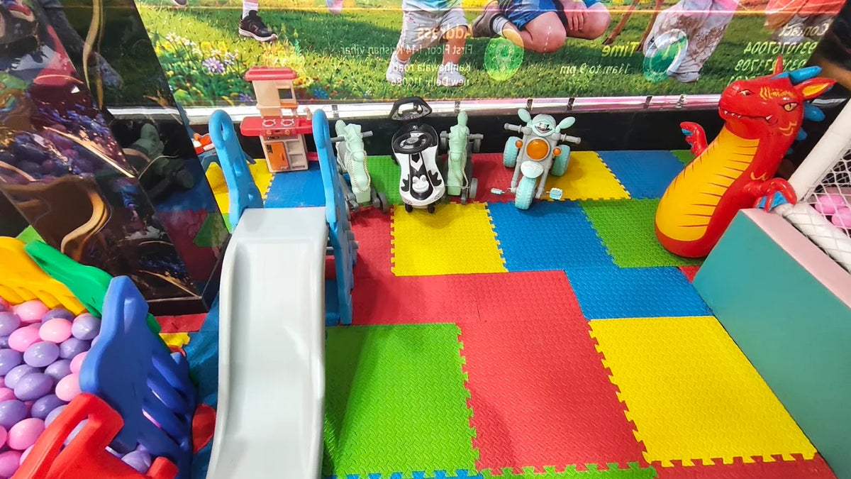 Children's play area with colorful mats, toys, and a slide.