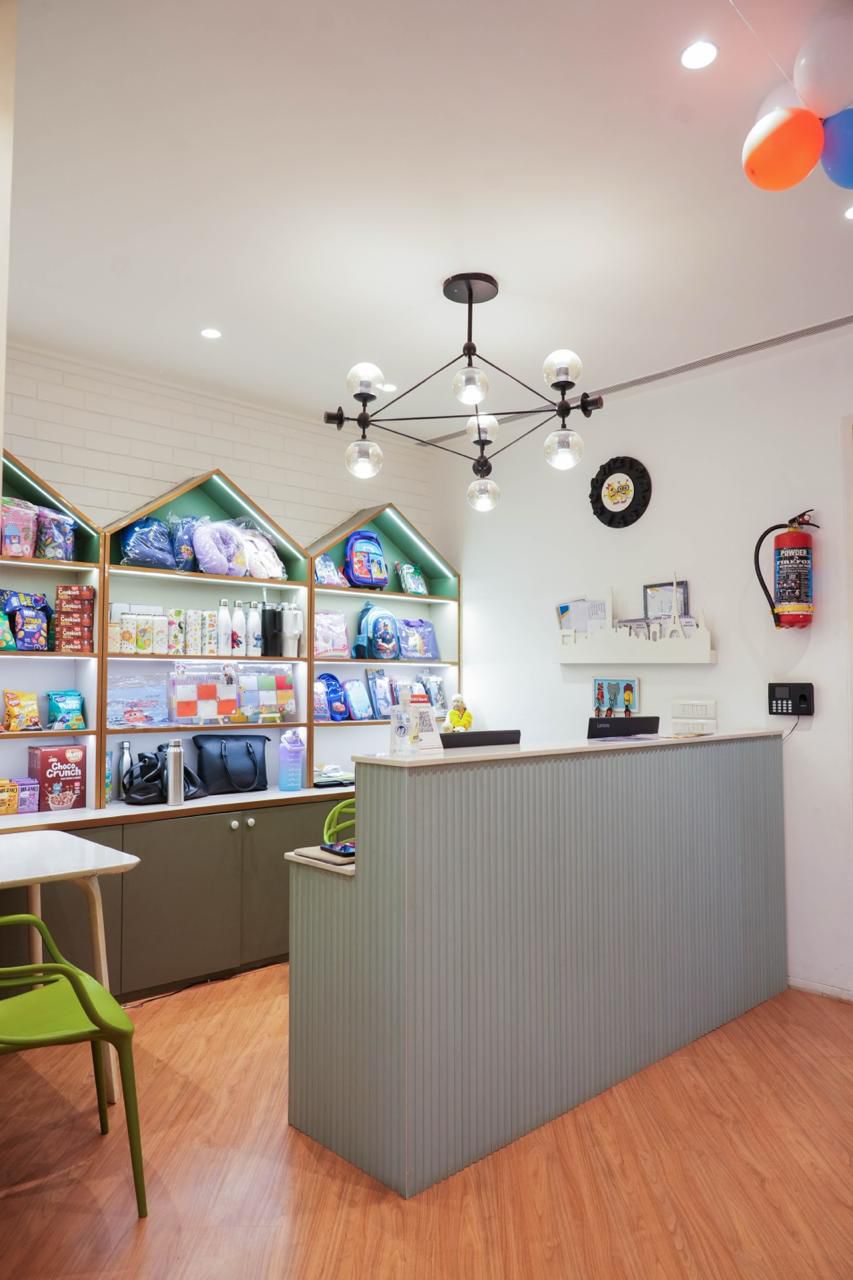 A retail store counter with shelves of children's products behind it.