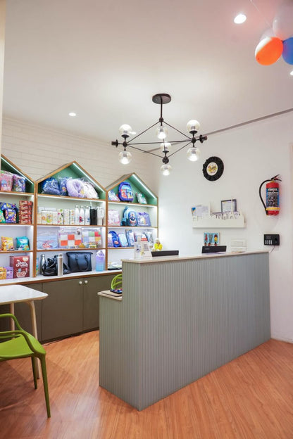 A retail store counter with shelves of children's products behind it.