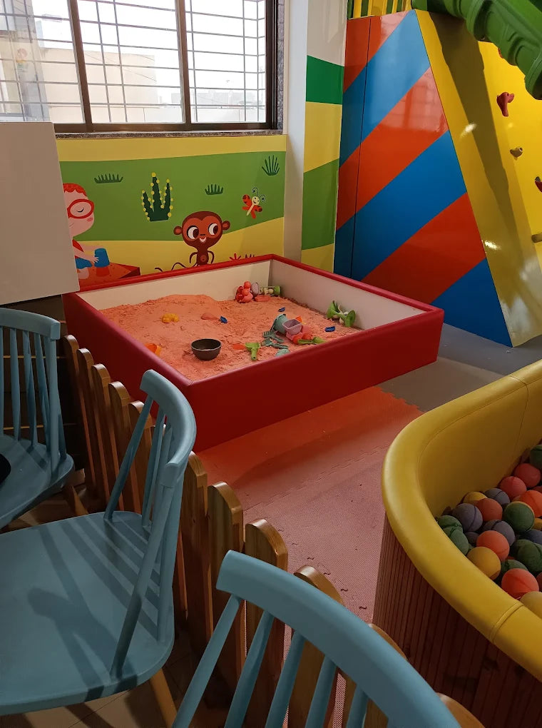 A sandbox and ball pit in a children's play area.