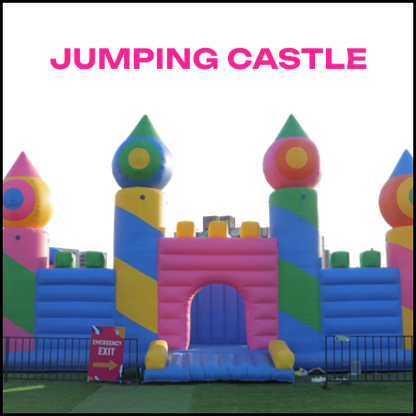 A colorful inflatable jumping castle with turrets and an arched entrance, set up on a grassy field.