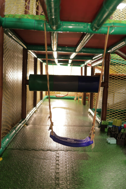 Indoor play tunnel with hanging blue swing and padded obstacle in Jumping Jollies Sector 104 Hazipur Noida