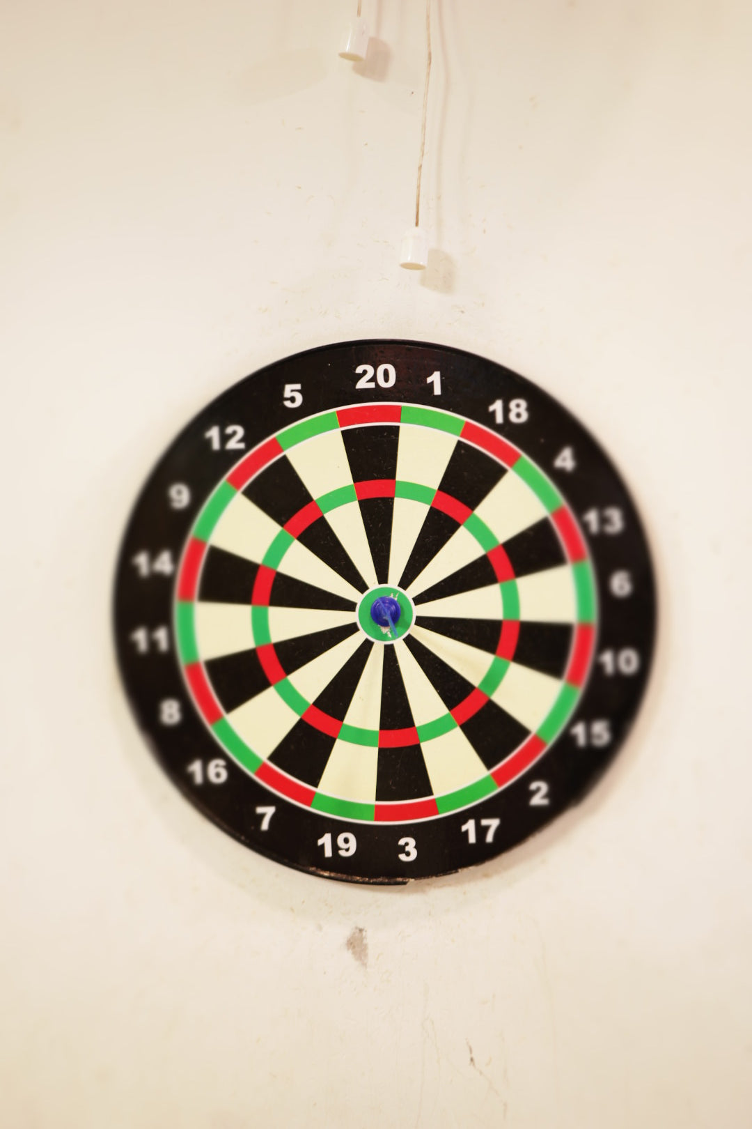 Close-up of classic dartboard mounted on plain wall inside Jumping Jollies indoor play area Sector 104 Hazipur Noida