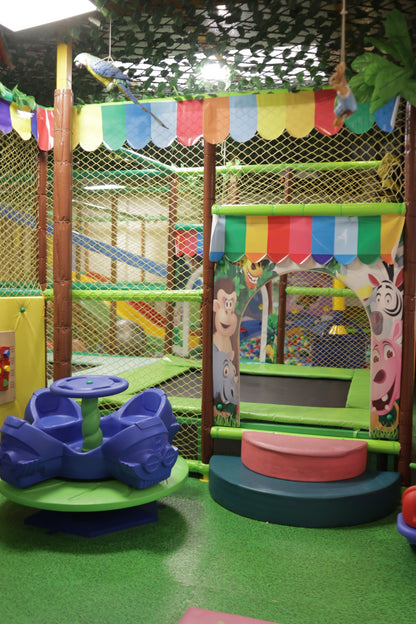 Indoor play corner with colorful canopy, animal-themed panels, and blue spinning ride in Sector 104 Hazipur Noida