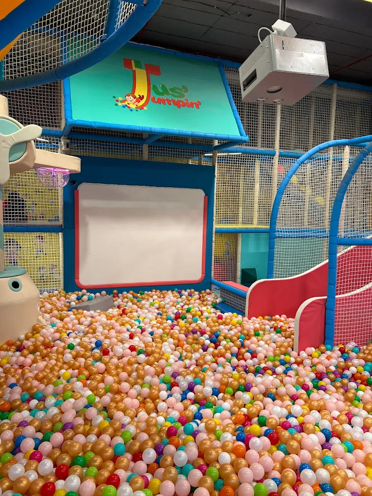 A ball pit filled with colorful balls in a children's play area.
