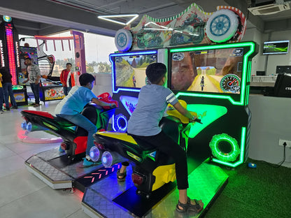 Two young boys play a motorcycle racing arcade game in an entertainment center.