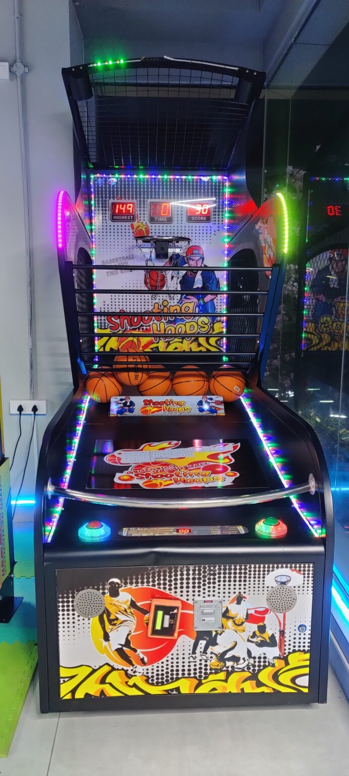 An arcade basketball game with colorful lights and graphics, featuring a digital score display and basketballs.