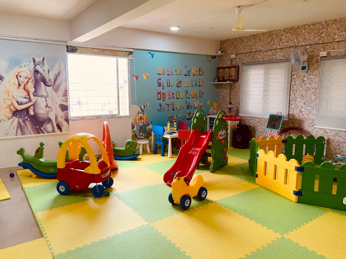 A colorful playroom for young children with toys, a slide, and a playpen.