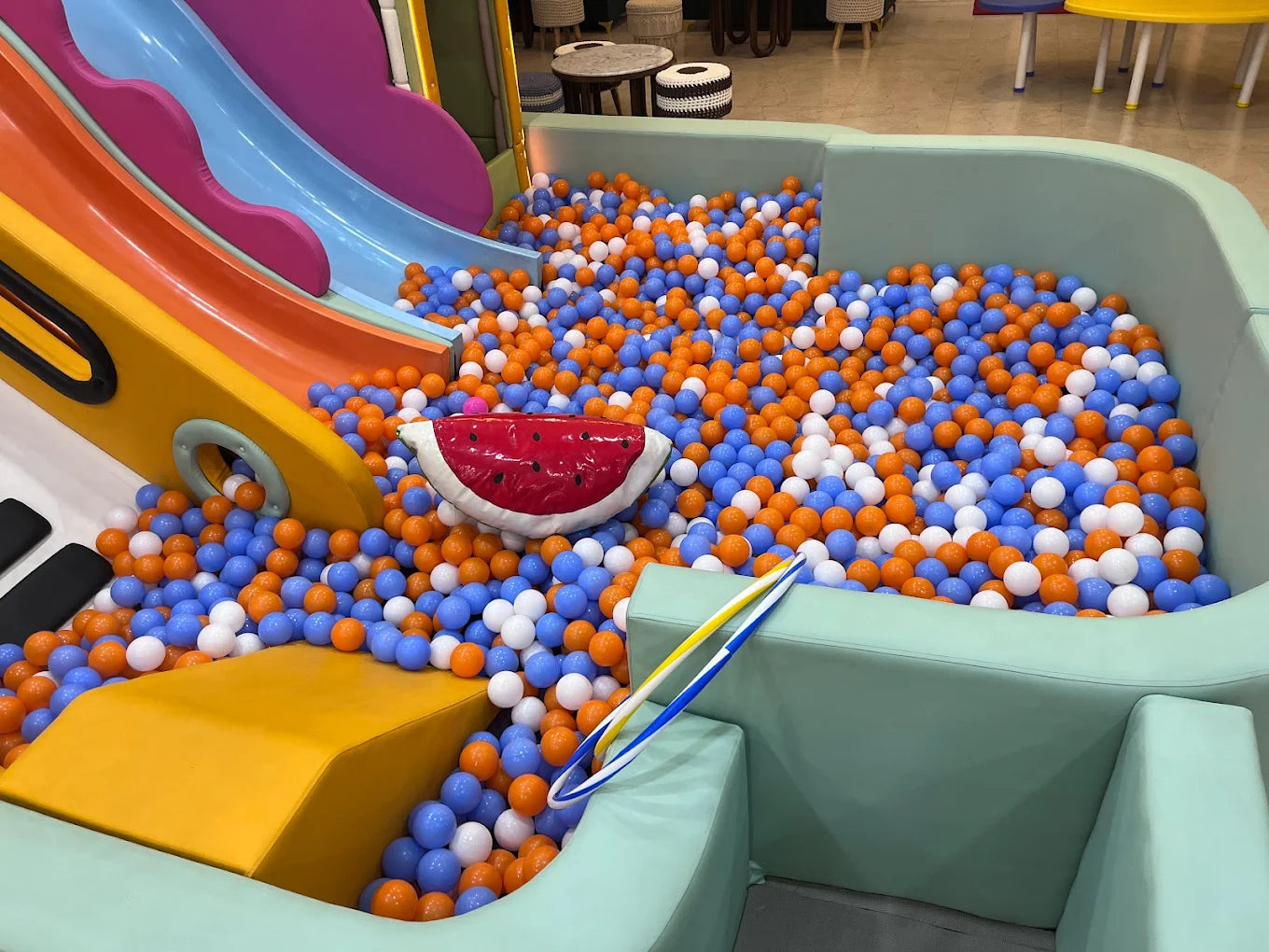 A ball pit with colorful balls and slides, a fun play area for children.