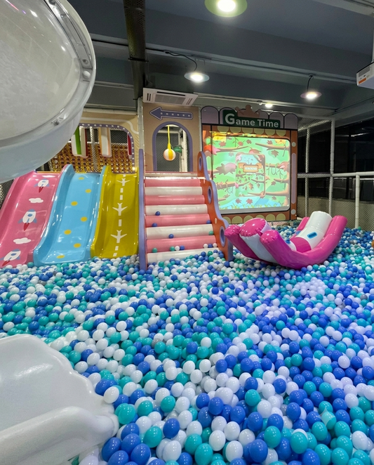 A colorful ball pit with slides and a "Game Time" screen, likely for young children.