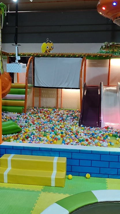 A colorful ball pit with slides and soft play equipment for children.