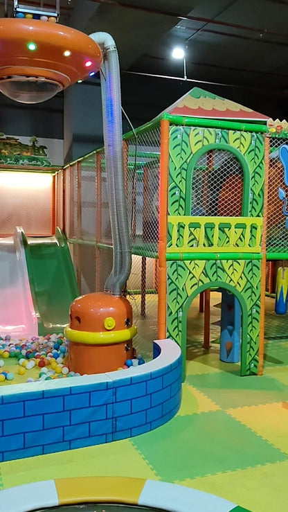 A colorful indoor playground with slides, a ball pit, and climbing structures for children.