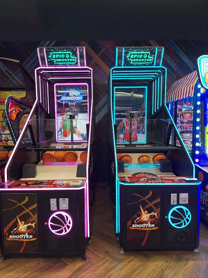 Two glowing arcade basketball games, "Epic Shooter," stand side-by-side in an arcade.