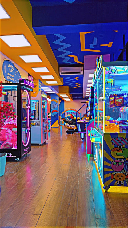 An arcade with colorful machines and neon lights, featuring games for children and adults.