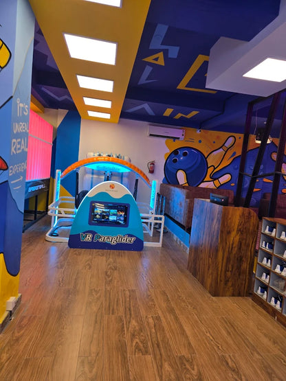 VR Paraglider attraction in a colorful entertainment center.