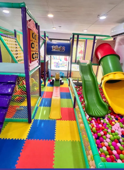 A colorful indoor playground with slides and a ball pit for children.