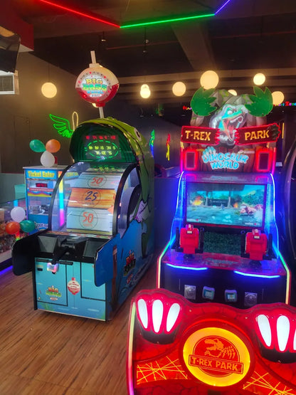 Two arcade games with colorful displays in an indoor setting