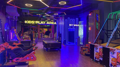 Children's play area with colorful lighting and various toys and games.