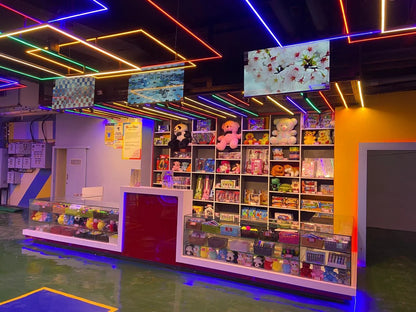 A brightly lit toy store with shelves full of stuffed animals and toys, and a checkout counter.