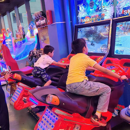 Children playing in an arcade with colorful lights and gaming machines.