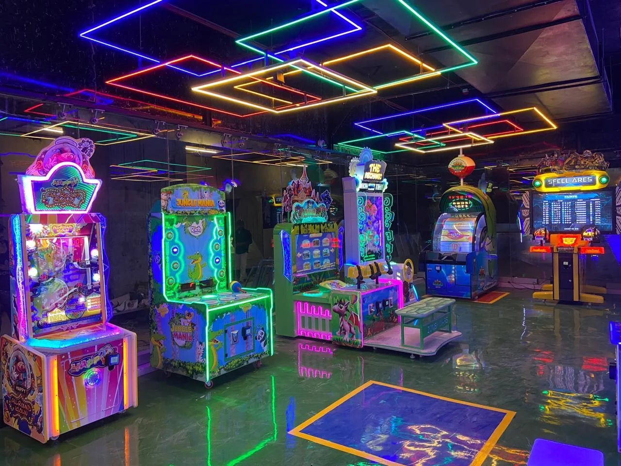 An arcade with colorful neon lights and various video games.