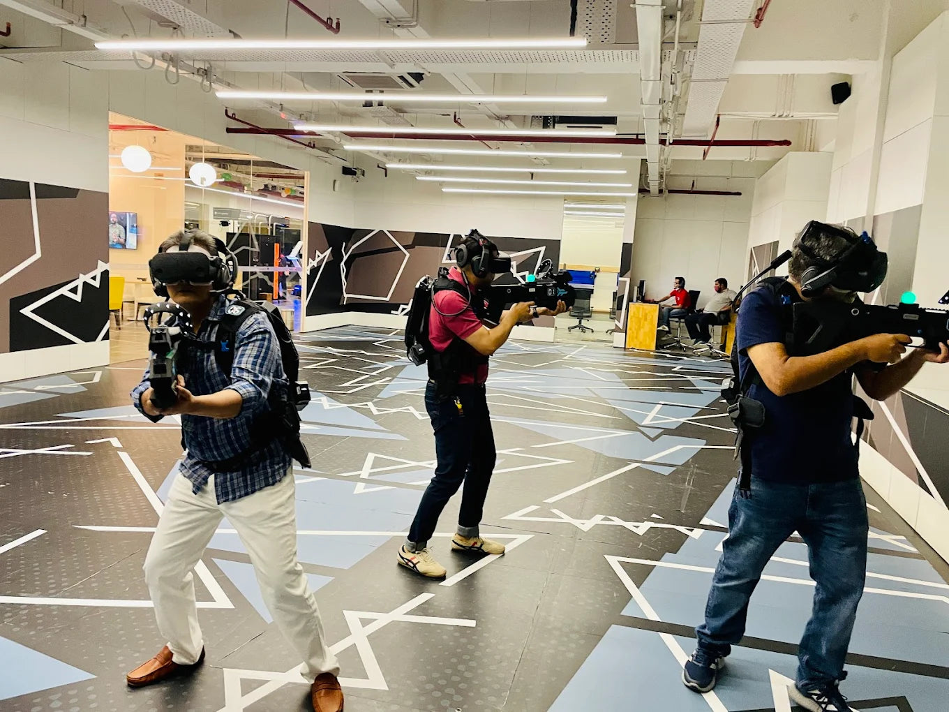 Three individuals with cameras in a modern indoor setting
