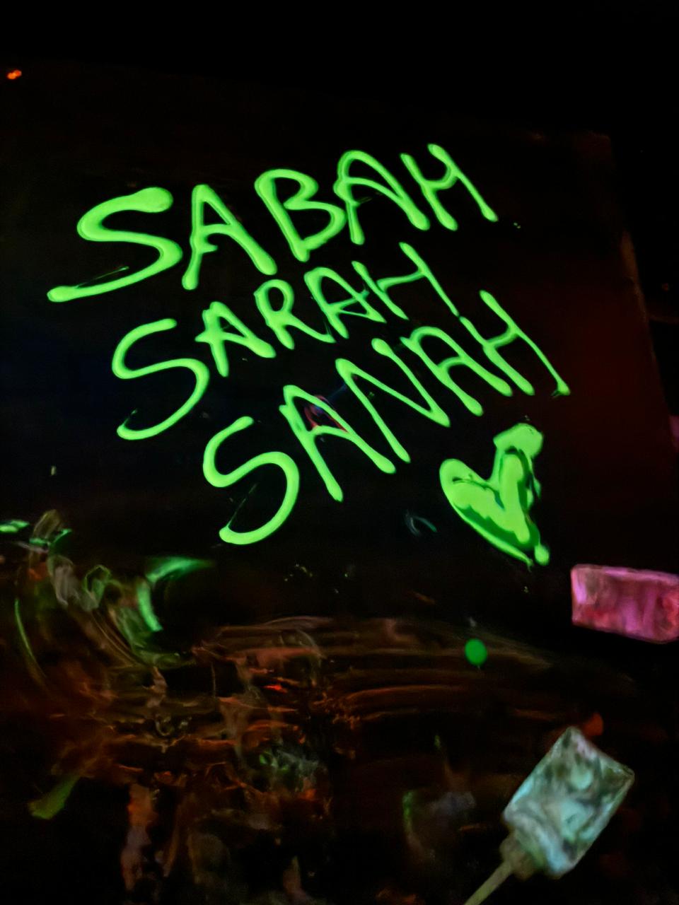 Neon green text on a black background reads "SABAH SARAH SANAH" with a heart shape.