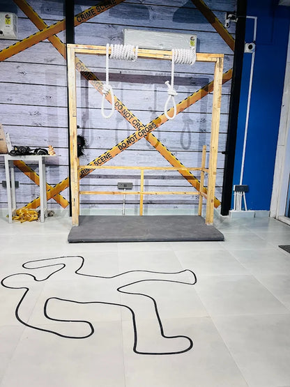 A crime scene setup with nooses and a chalk outline on the floor.