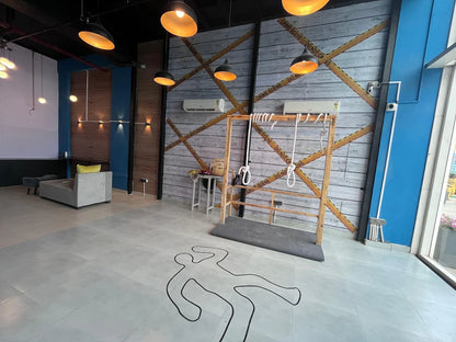 A crime scene-themed room with a chalk outline on the floor and yellow caution tape on the wall.