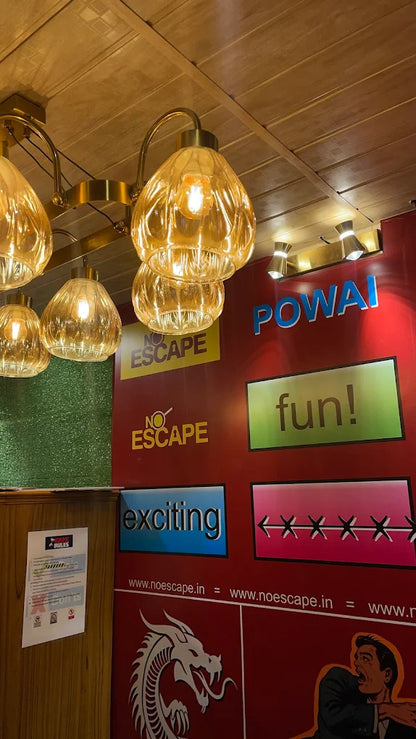 A red wall with escape room signs, lights, and a dragon graphic.