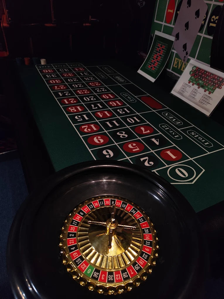 Close-up of roulette wheel and betting layout under low light inside No Escape Room by Gaming Universe Rajinder Nagar
