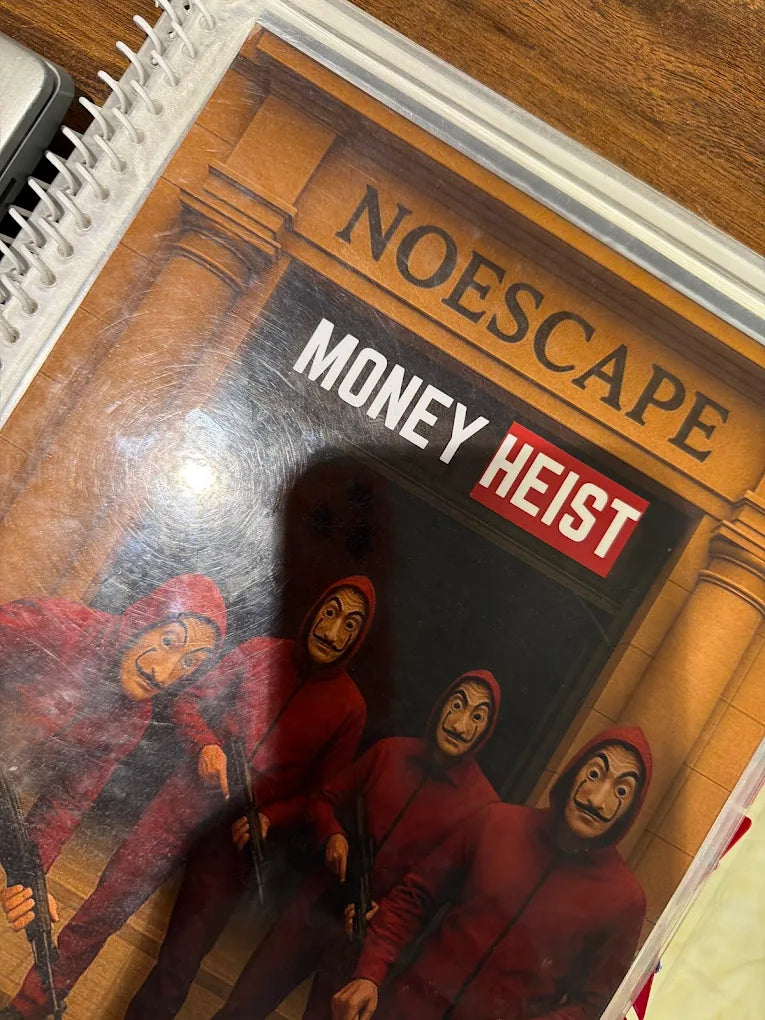 A group of people in red jumpsuits and masks stand in front of a building with "NOESCAPE MONEY HEIST" written above them.