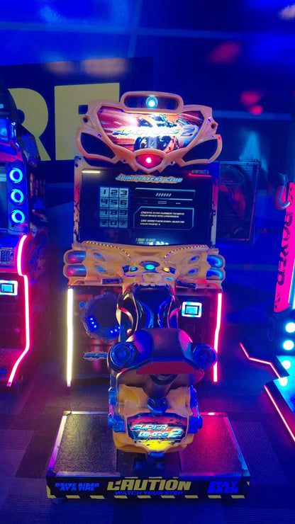 A brightly lit arcade game featuring a motorcycle ride, with neon lights and a "Caution" sign.