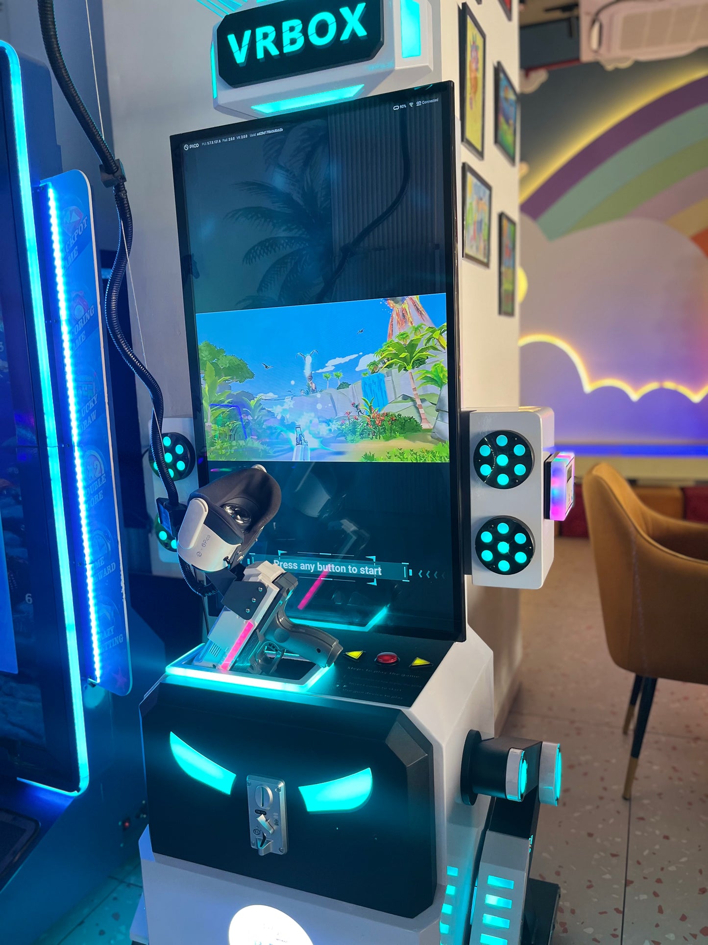 A VR arcade game with a virtual reality headset and gun, set in a colorful entertainment space.