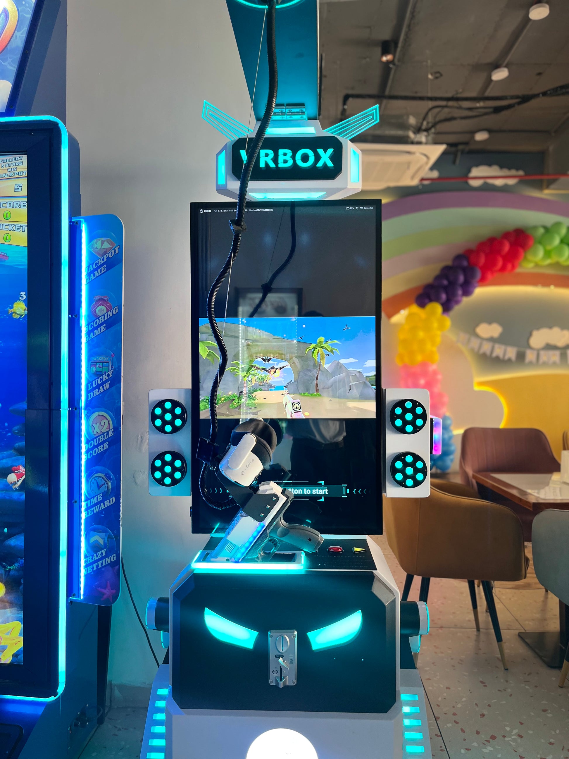 A VR arcade game machine with a gun controller and a screen displaying a game.