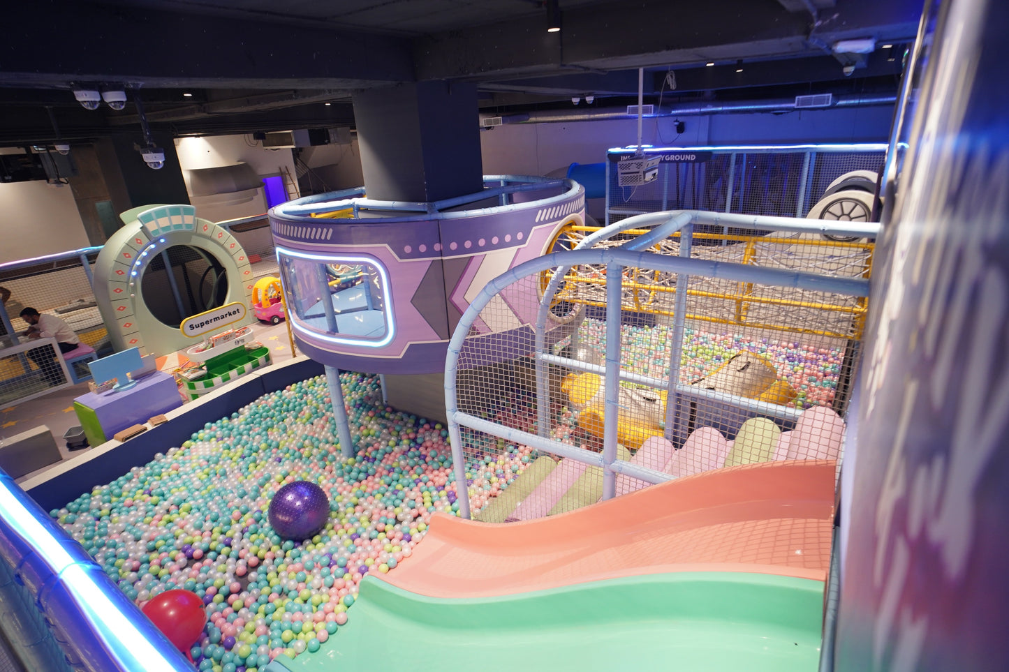Children's indoor play area with colorful ball pit and playground equipment.