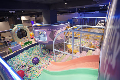 Children's indoor play area with colorful ball pit and playground equipment.
